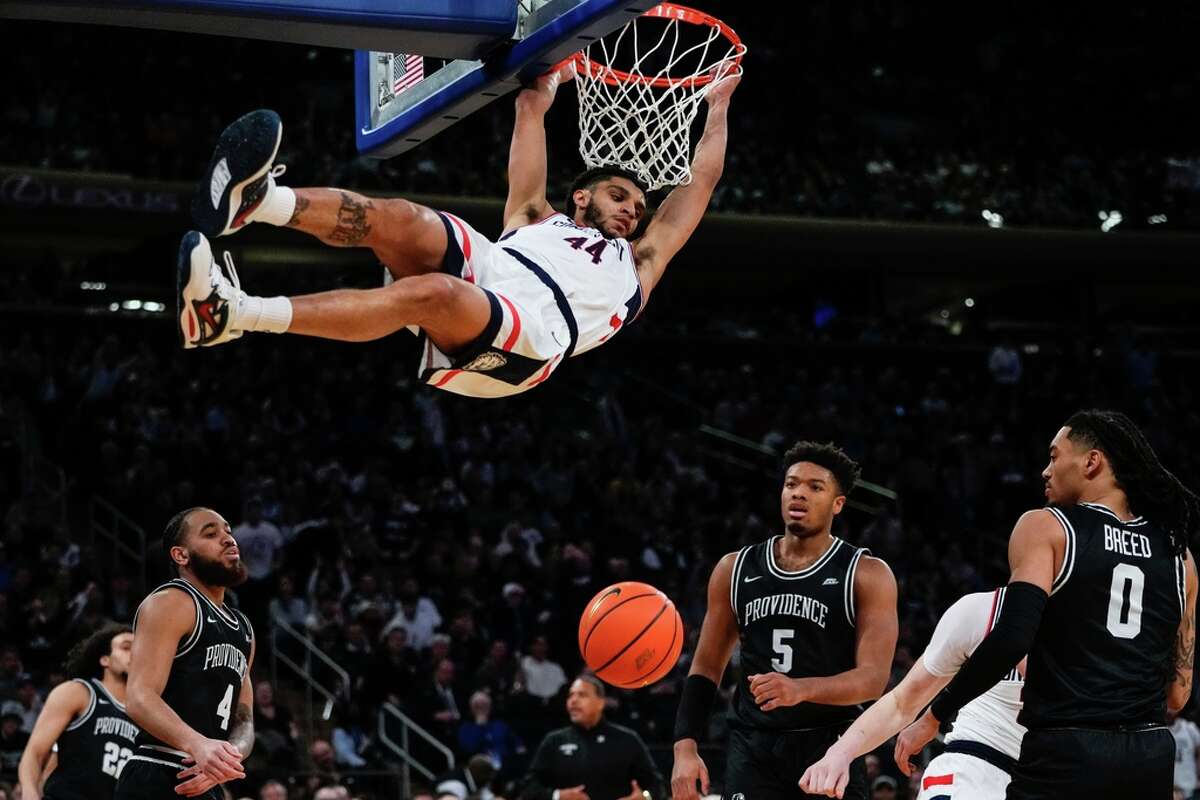 Connecticut's Andre Jackson Jr. (44) dunks the ball in front of Providence's Jared Bynum (4), Alyn Breed (0) and Ed Croswell (5) during the first half of an NCAA college basketball game in the quarterfinals of the Big East Conference Tournament, Thursday, March 9, 2023, in New York. (AP Photo/Frank Franklin II)