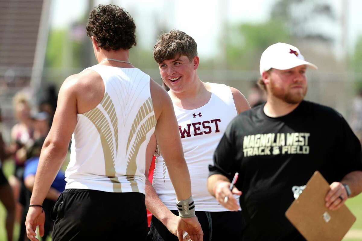 Magnolia West’s Warren Ehler, center, reacts after teammate Sam Mattingly’s throw in the shot put during the Dog Pound Invitational, Thursday, March 9, 2023, in Magnolia.
