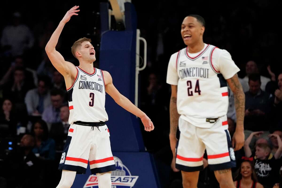 Connecticut's Joey Calcaterra, left, celebrates with Jordan Hawkins after making a three-point shot during the first half of an NCAA college basketball game in the quarterfinals of the Big East Conference Tournament Thursday, March 9, 2023, in New York. (AP Photo/Frank Franklin II)