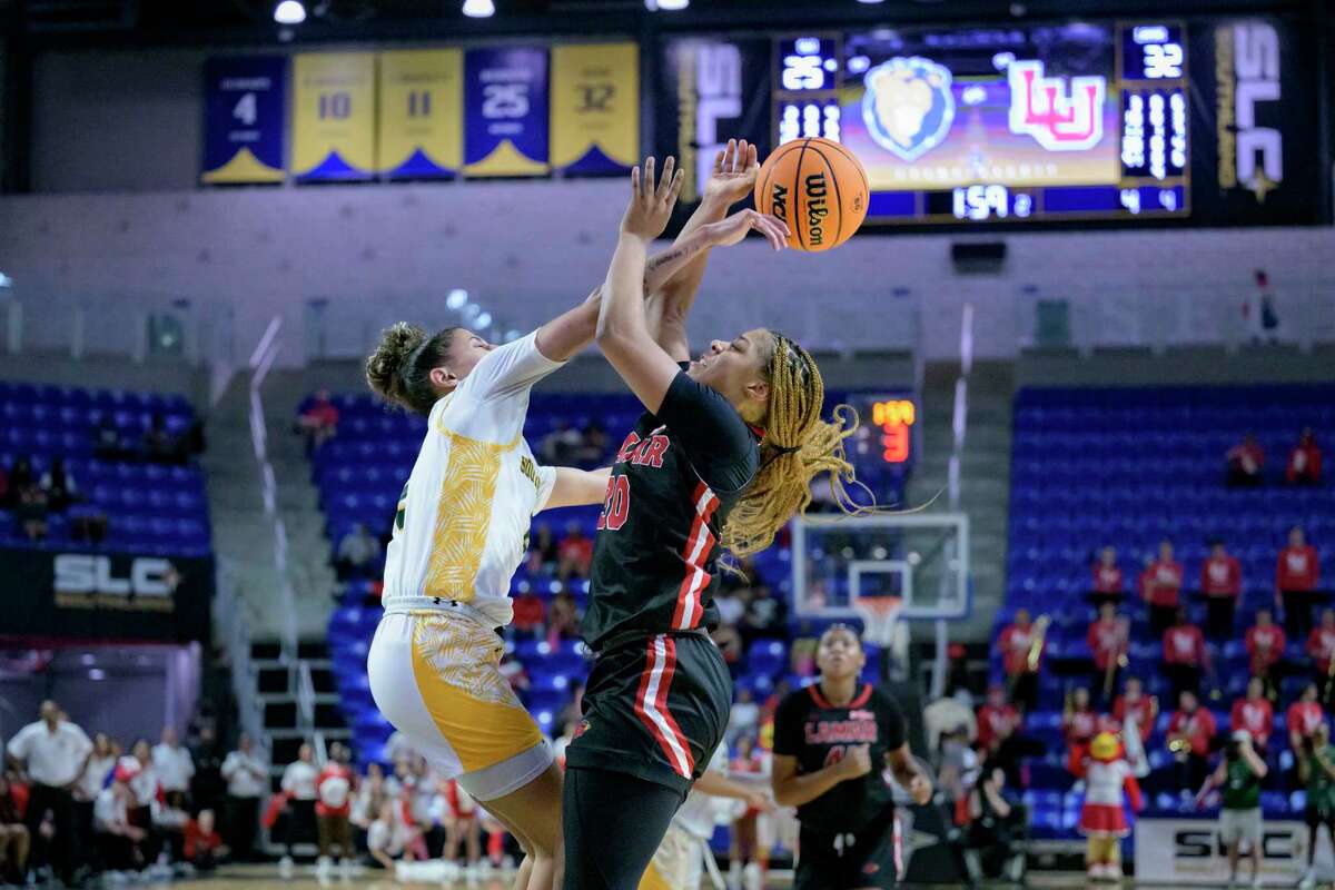 Southeastern Louisiana guard Cierria Cunningham, left, blocks a shot by Lamar guard R'Mani Taylor (30) during the first half an NCAA college basketball game in the finals of the Southland Conference women's tournament in Lake Charles, La., Thursday, March 9, 2023. (AP Photo/Matthew Hinton)