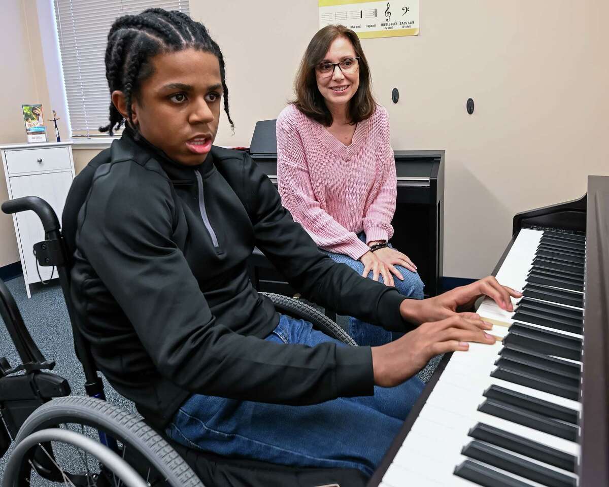 Christopher Harrison plays the piano at Creative Harmonies Music Studio while teacher and studio owner Dee Cucinotta watches on Wednesday, March 8, 2023, in Colonie, NY.