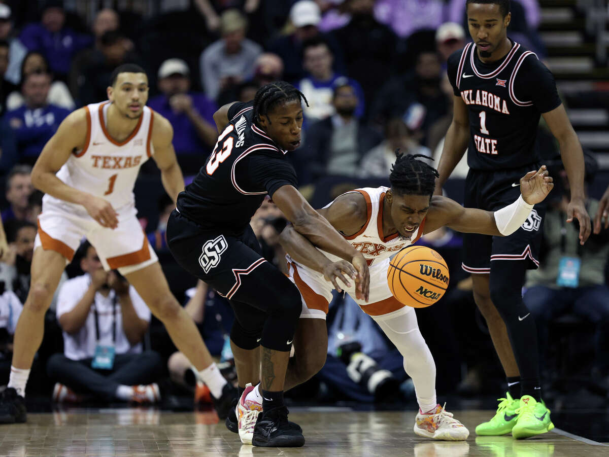 KANSAS CITY, MISSOURI - MARCH 09: Quion Williams #13 of the Oklahoma State Cowboys and Marcus Carr #5 of the Texas Longhorns compete for a loose ball during the Big 12 Tournament game at T-Mobile Center on March 09, 2023 in Kansas City, Missouri. (Photo by Jamie Squire/Getty Images)