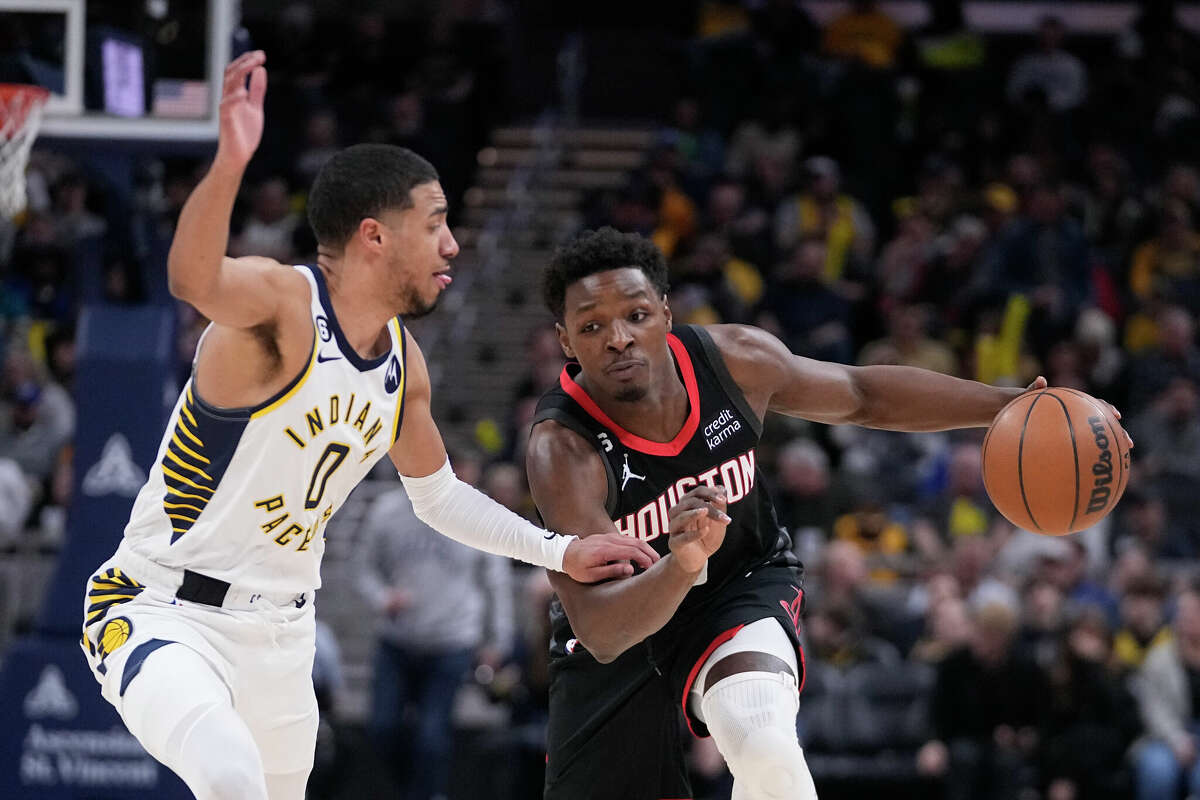Houston Rockets' Jae'Sean Tate (8) goes to the basket against Indiana Pacers' Tyrese Haliburton (0) during the first half of an NBA basketball game, Thursday, March 9, 2023, in Indianapolis. (AP Photo/Darron Cummings)