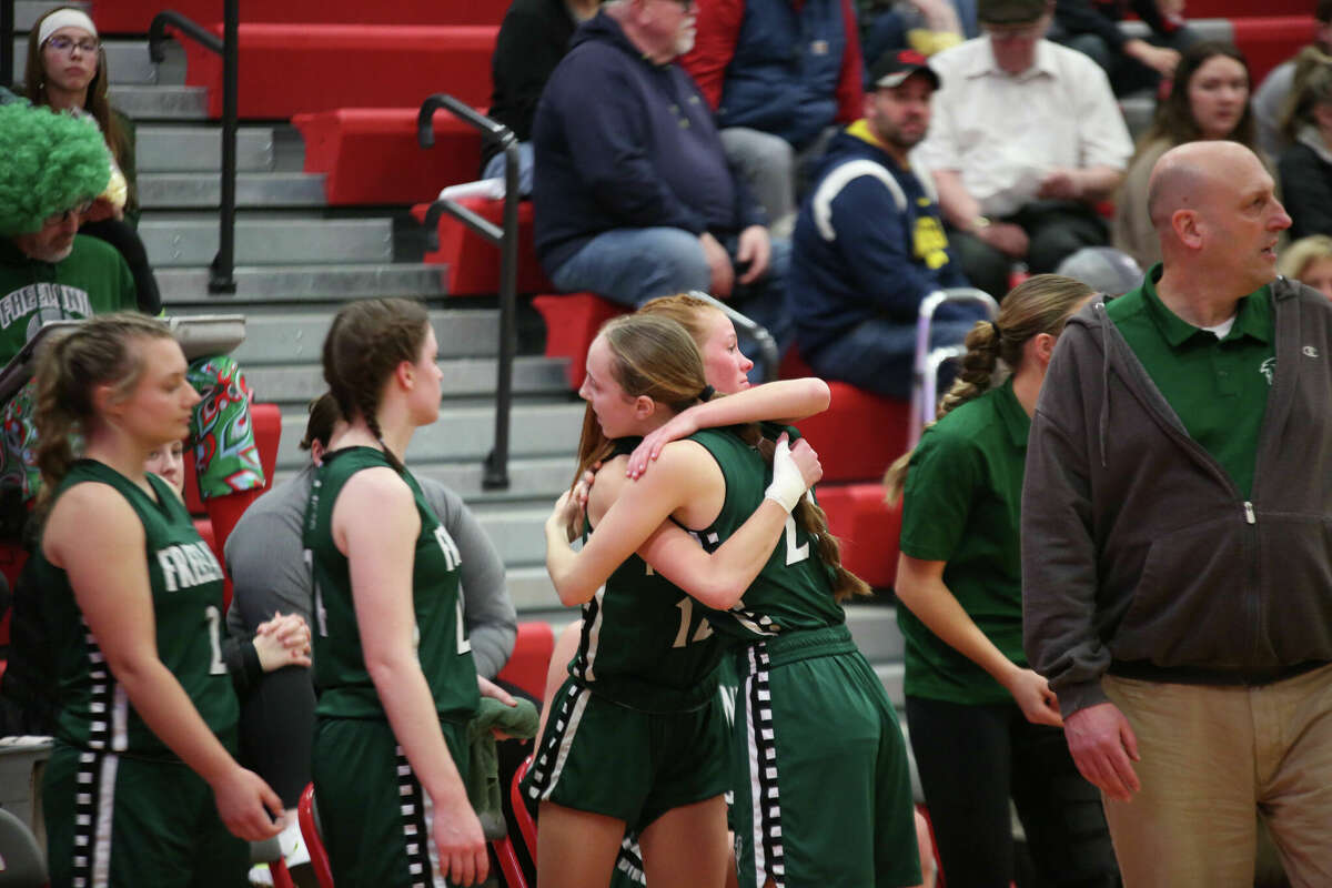Freeland's Karie Keefer (right) hugs teammate Haven Vasold near the end of Thursday's regional final against Frankenmuth, March 9, 2023.