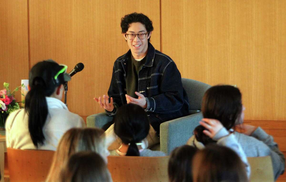 Olympic gold medalist Nathan Chen reads his picture book "Wei Skates On" and signs copies of the book as well at Darien Library in Darien, Conn., on Thursday March 9, 2023.
