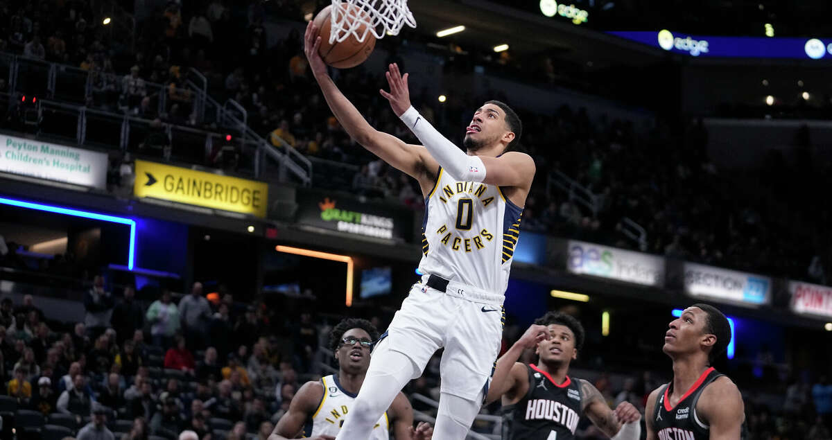 Indiana Pacers' Tyrese Haliburton (0) puts up a shot against Houston Rockets' Jabari Smith Jr. (1) during overtime of an NBA basketball game, Thursday, March 9, 2023, in Indianapolis. (AP Photo/Darron Cummings)