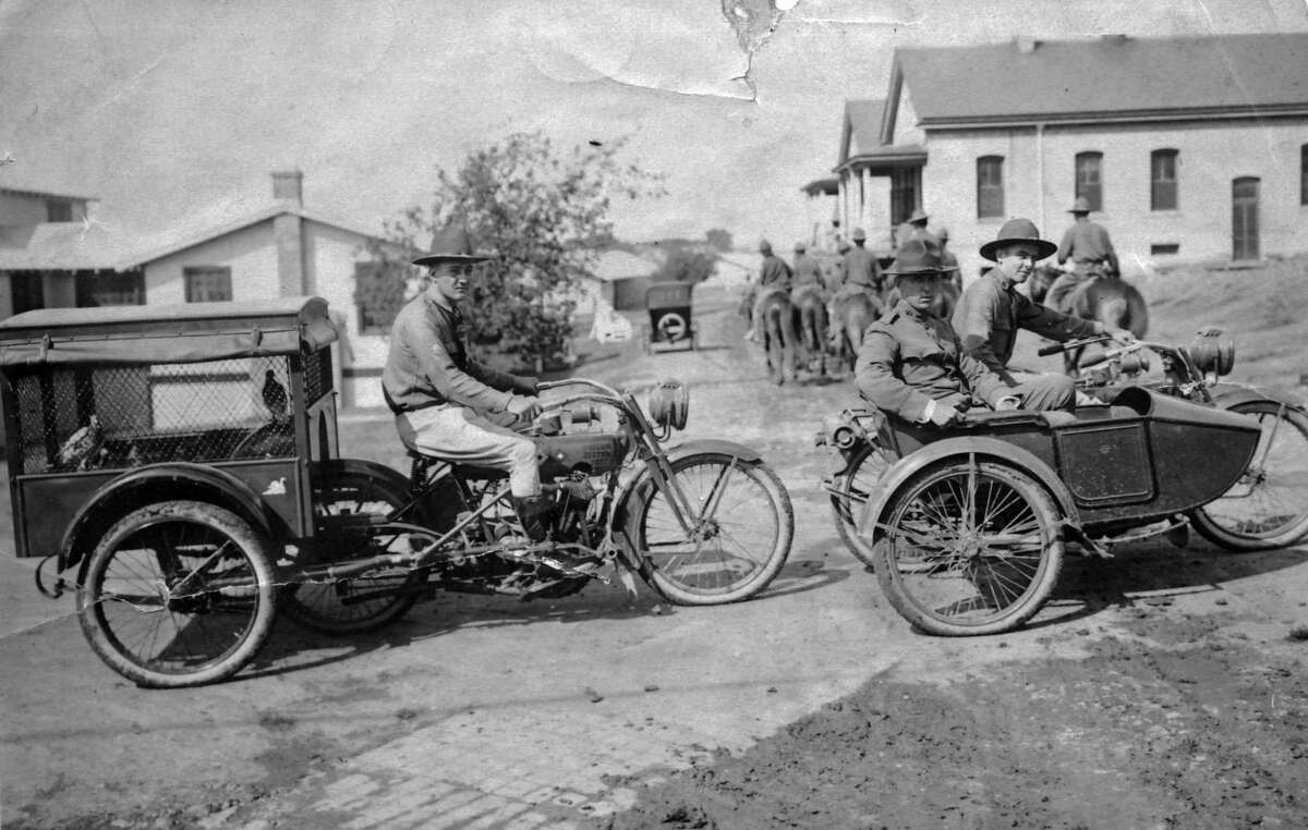 In 1917, an Army “pigeoneer” transports his charges in a trailer specially built to be towed by a motorcycle for a training flight. The pigeons would be released many miles away, and their times recorded as they arrived at home.