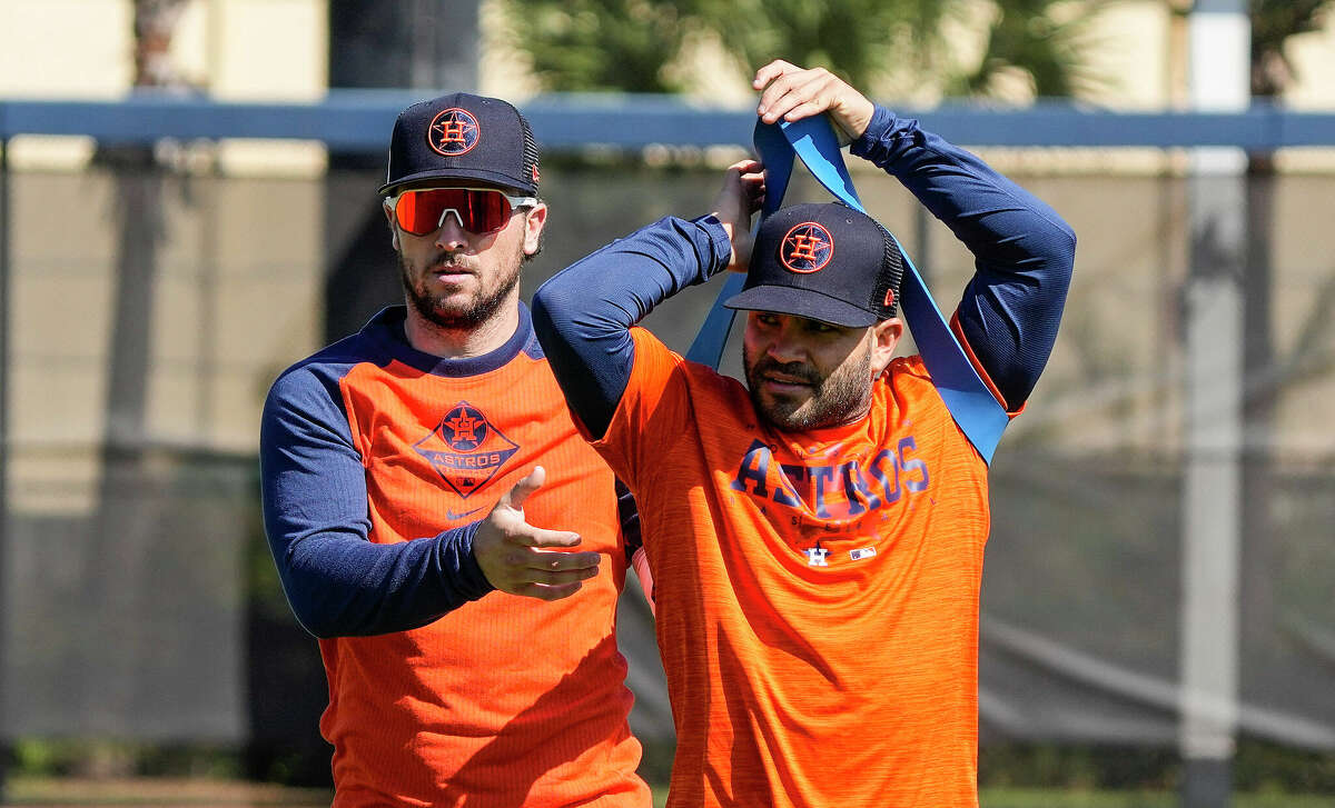 Houston Astros second baseman Jose Altuve puts on a resistance band as he and Alex Bregman warmed up during the first full squad workout at the Astros spring training complex at The Ballpark of the Palm Beaches on Tuesday, Feb. 21, 2023 in West Palm Beach .