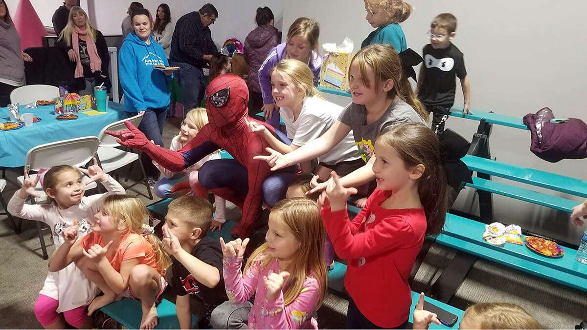 Noah Allen dressed as Spider-Man and surrounded by kids at a birthday party where he made an appearance. Since then, dressing as the web-swinger has become a common occurrence.