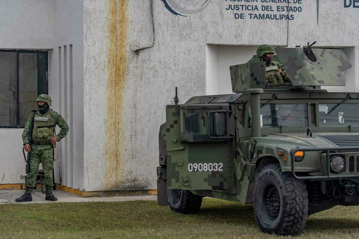 Soldiers on patrol at the Forensic Medical Service after two Americans were killed and two were kidnapped, in Matamoros, Mexico, March 8, 2023. Five men, lying face down with their hands tied, were found by the Mexican authorities on Thursday along with a letter purportedly written by a powerful criminal cartel, blaming the men for a recent attack on four Americans, according to two people familiar with the investigation. (Alejandro Cegarra/The New York Times)