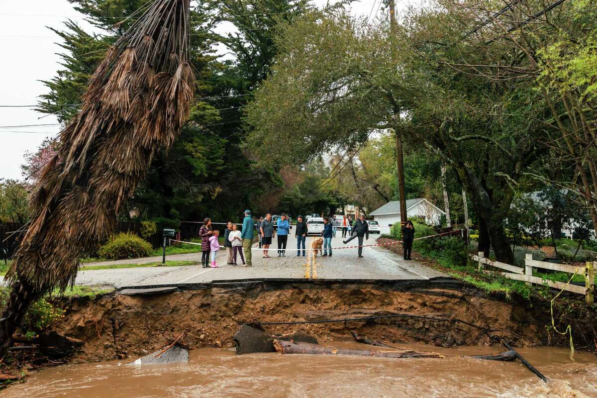 Residents look at the damage to North Main Street in Soquel (Santa Cruz County) that resulted from the state’s latest atmospheric river event.