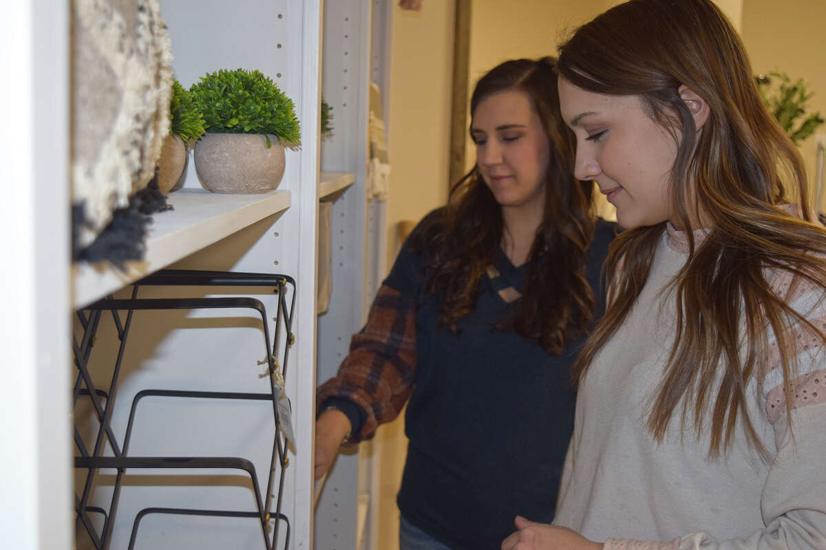 Sisters Alison McGrane (right) and Lauren Tomhave are opening Rooted Homestead, a home goods store, inside The Plaza on the downtown square.