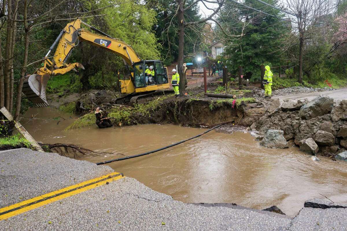 Crews assess storm damage, which washed out North Main Street in Soquel, Calif., Friday, March 10, 2023.
