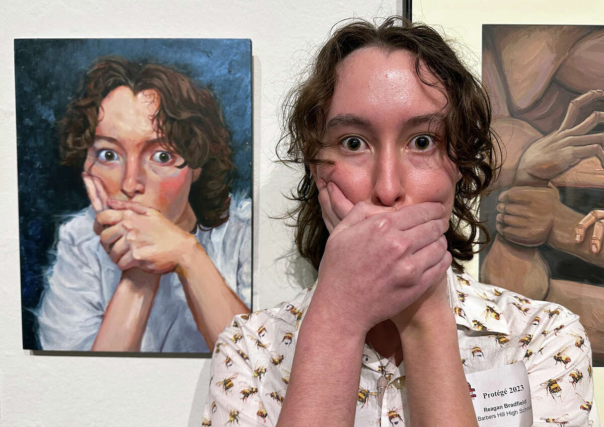 Reagan Bradfield poses with her painting "The Artist." Bradfield earned first place in the Art Museum of Southeast Texas' Protégé 2023 art competition. Photo by Andy Coughlan