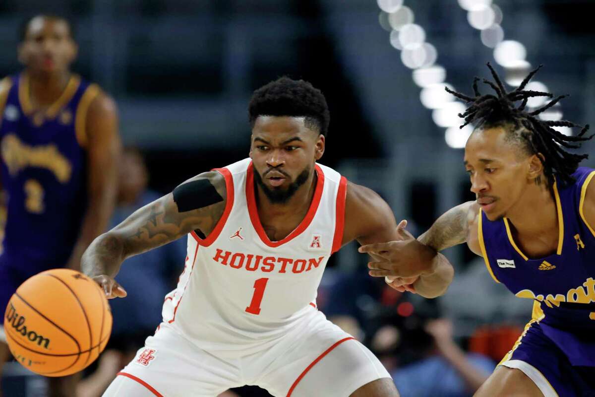 Houston guard Jamal Shead (1) steals the ball from East Carolina guard Jaden Walker during the first half of an NCAA college basketball game in the quarterfinals of the American Athletic Conference Tournament, Friday, March 10, 2023, in Fort Worth, Texas.