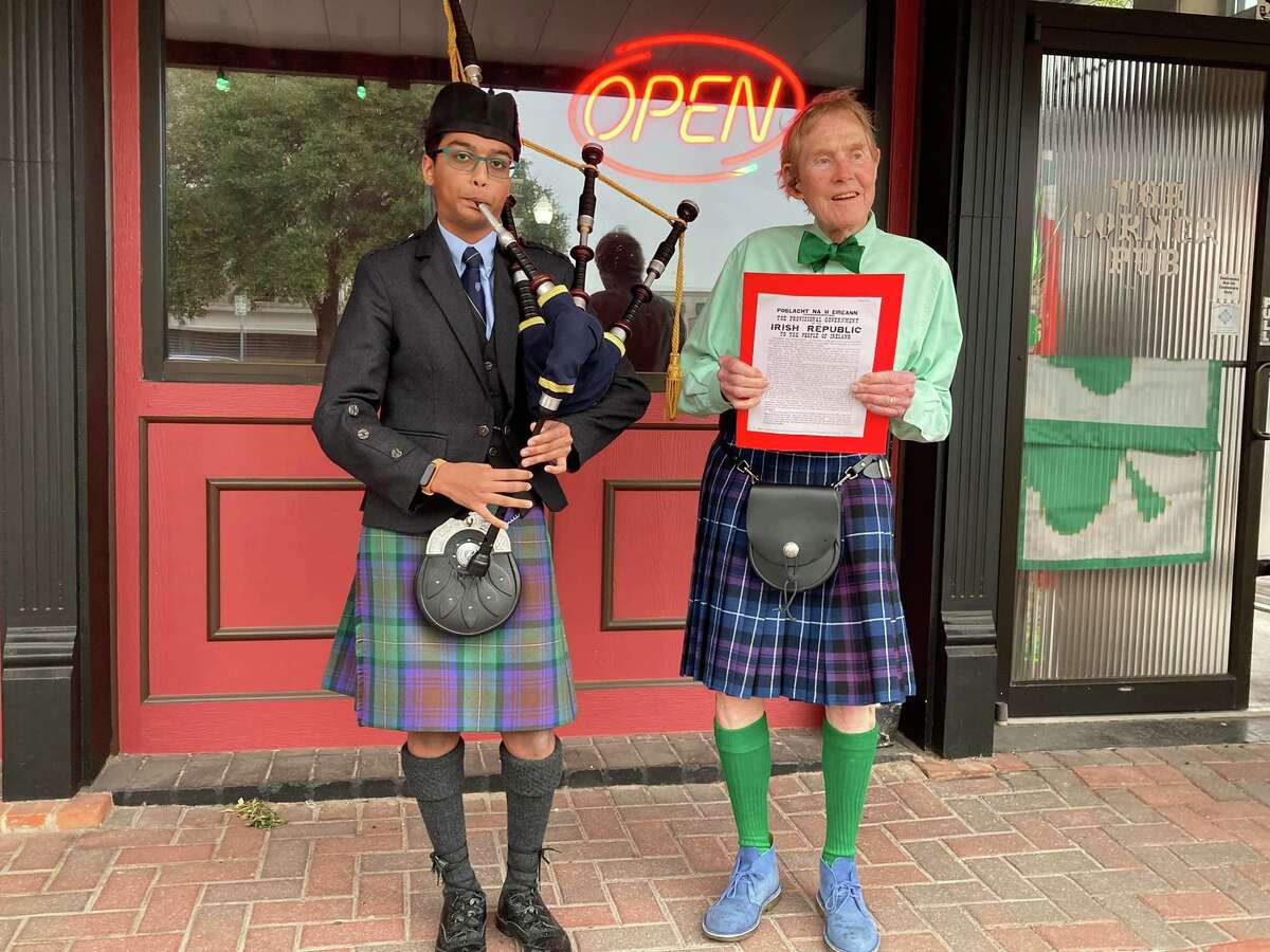 Mihir Zambre, left, a student at Houston’s St. Thomas Episcopal School, and bagpiper for the annual Conroe St. Patrick’s Day Walking Parade is pictured with parade founder Mike McDougal as he reads an Irish proclamation.
