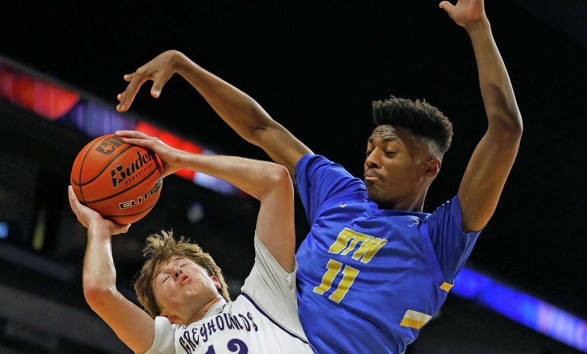 Houston Washington Chris McDermott (11) blocks shot of Boerne Barrett Pape (12). Houston Washington defeated Boerne 75-69 in a Class 4A state semifinal on Thursday, March 10 ,2023 at the Alamodome.
