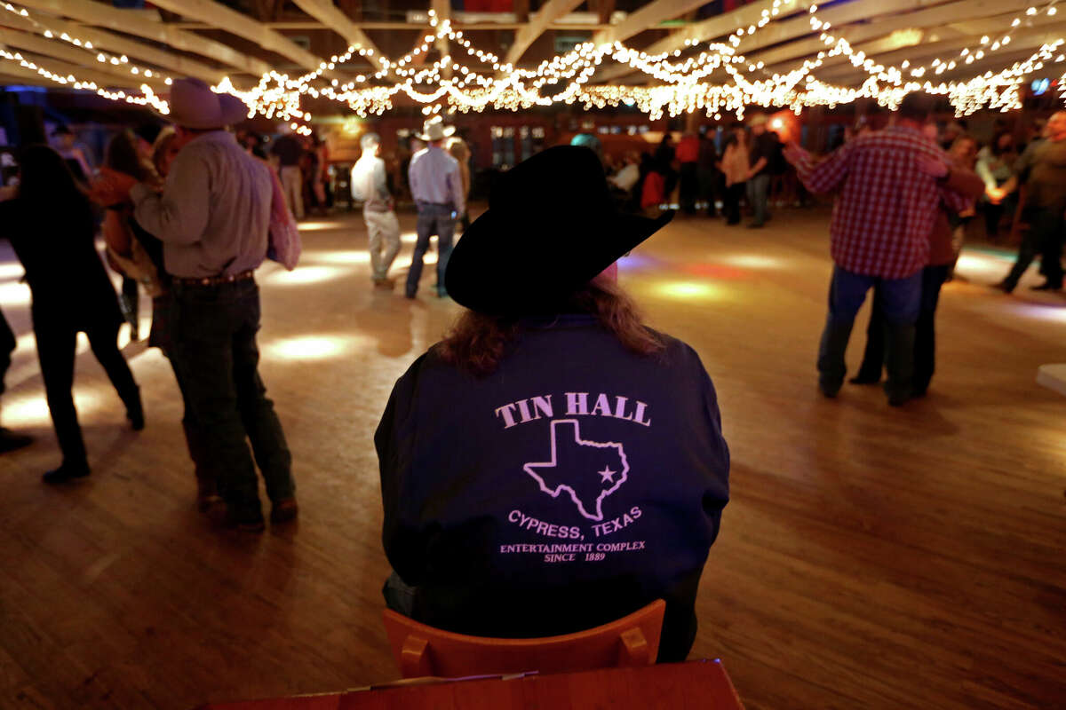 File photo: Tin Hall will be restored and revived in a new location in the Cypress Tomball area, where owners also plan to operate a new home for Harris County Fair and Rodeo. Pictured is a 2015 file photo showing patrons dancing to country music as they rang in the New Year at Tin Hall Thursday, Dec. 31, 2015, in Cypress, Texas. After 126 years, Tin Hall, the largest, oldest and only dance hall in Harris County, closed its doors after a New Year's Eve event. ( Gary Coronado / Houston Chronicle )