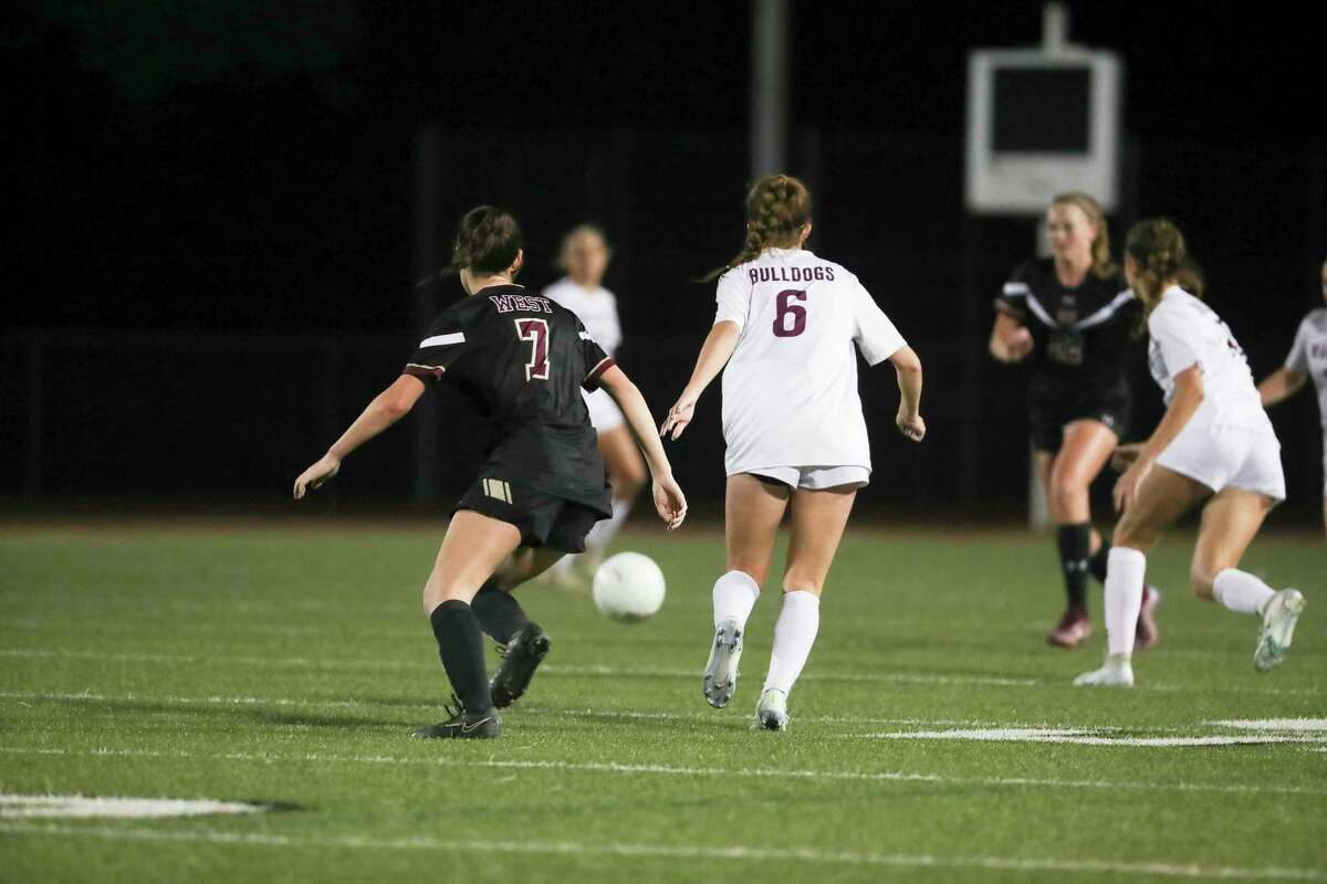 Magnolia’s Haley Baird (6) battles for position against Magnolia West’s Curtly McCallum (7) during the first half of a District 21-5A high school soccer match at Magnolia West High School, Friday, March 10, 2023, in Magnolia.
