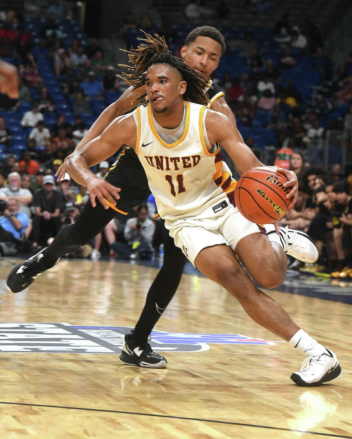 Beaumont United's Kayde Dotson drives the ball down court as the Timberwolves take on Brennan in the 6A state semi final at the Alamodome Friday. Photo made Friday, March 10, 2023 Kim Brent/Beaumont Enterprise