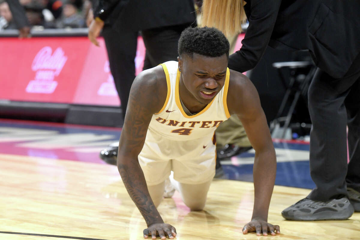 Trealyn Porchia reacts after being injured as Beaumont United takes on Brennan in the 6A state semi final at the Alamodome Friday. Photo made Friday, March 10, 2023 Kim Brent/Beaumont Enterprise