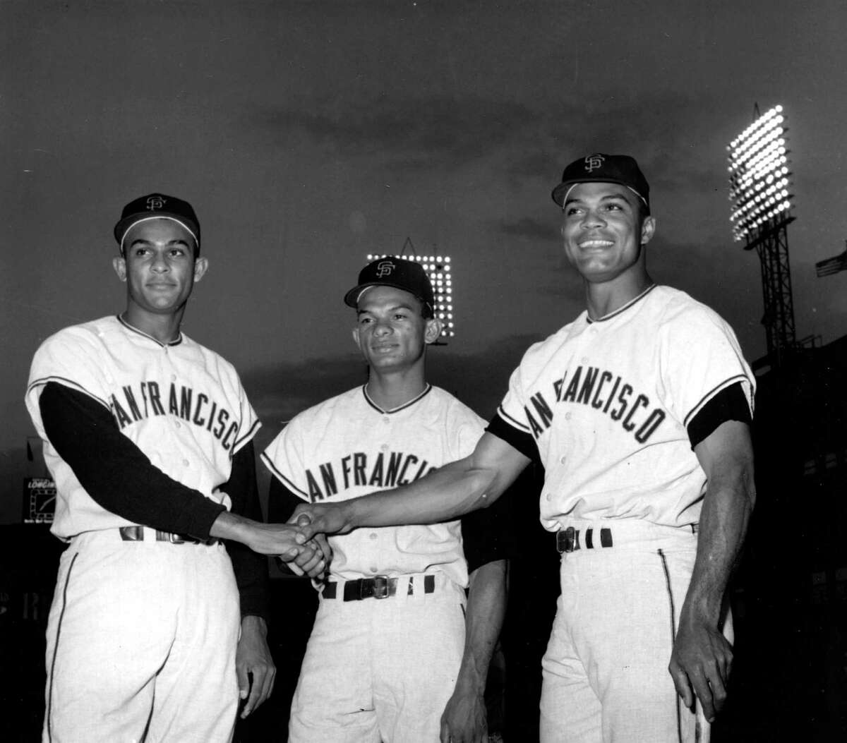 San Francisco outfielders, from left, Jesus Alou, Matty Alou and Felipe Alou, of the Dominican Republic, pose in a three-way hand shake before start of a baseball game with the New York Mets at New York’s Polo Grounds in 1963.