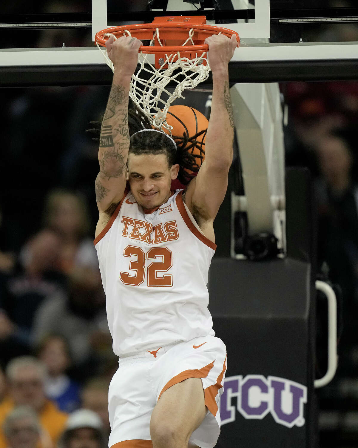 Texas forward Christian Bishop dunks the ball during the first half of an NCAA college basketball game against TCU in the semifinal round of the Big 12 Conference tournament Friday, March 10, 2023, in Kansas City, Mo. (AP Photo/Charlie Riedel)
