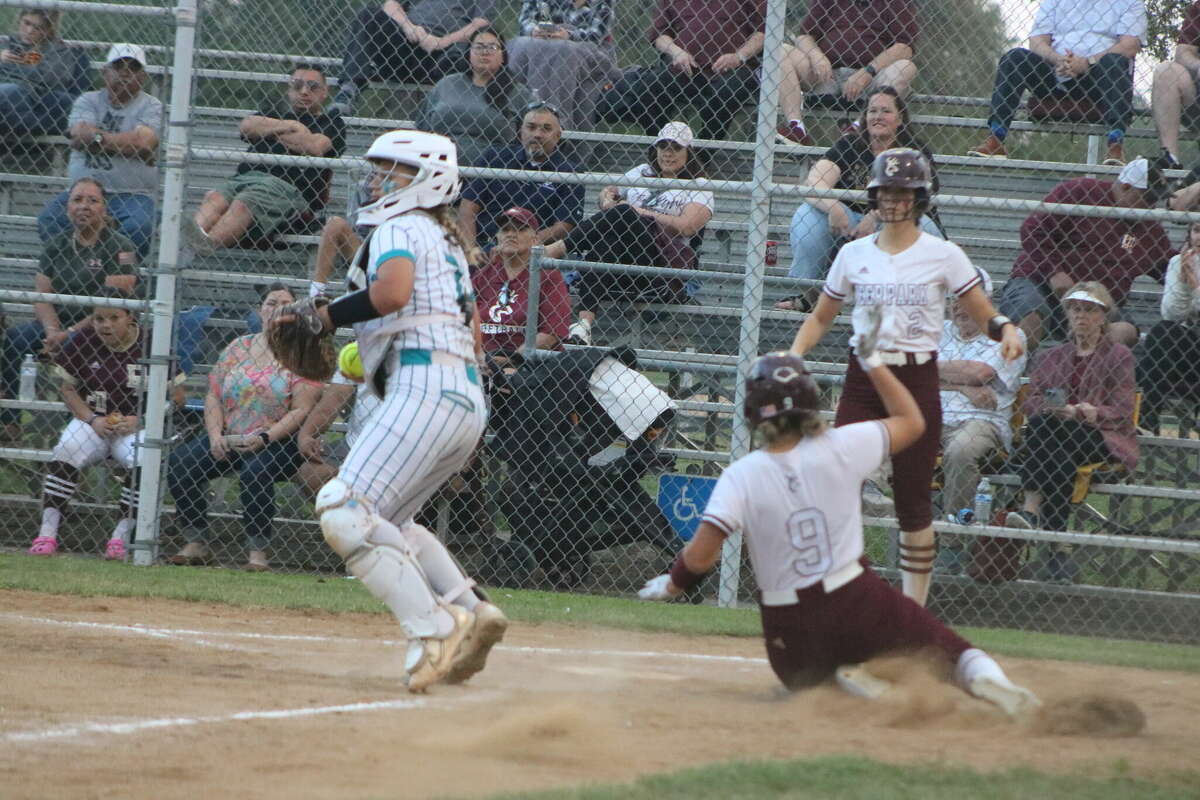 Deer Park's Bryanna Fuentes slides home with a first-inning run Friday night as Kaitlyn Zaid looks on. Angelina Morales knocked in two with a single to center.