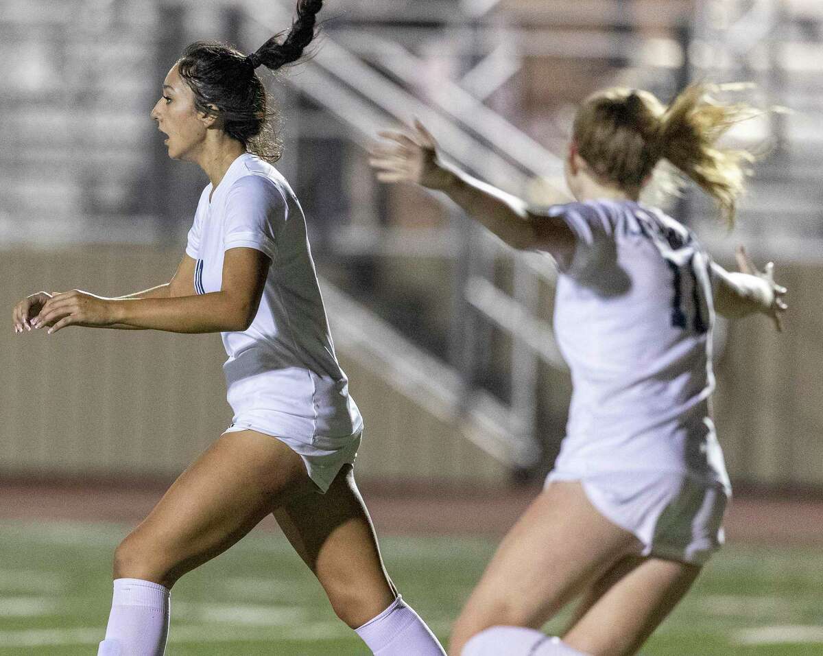 Johnson’s Camila Palacios, left, celebrates her first half goal with teammates Mabry Williams Friday night, Match 10, 2023, at Comalander Stadium during the Jaguars’ game against the Vols.