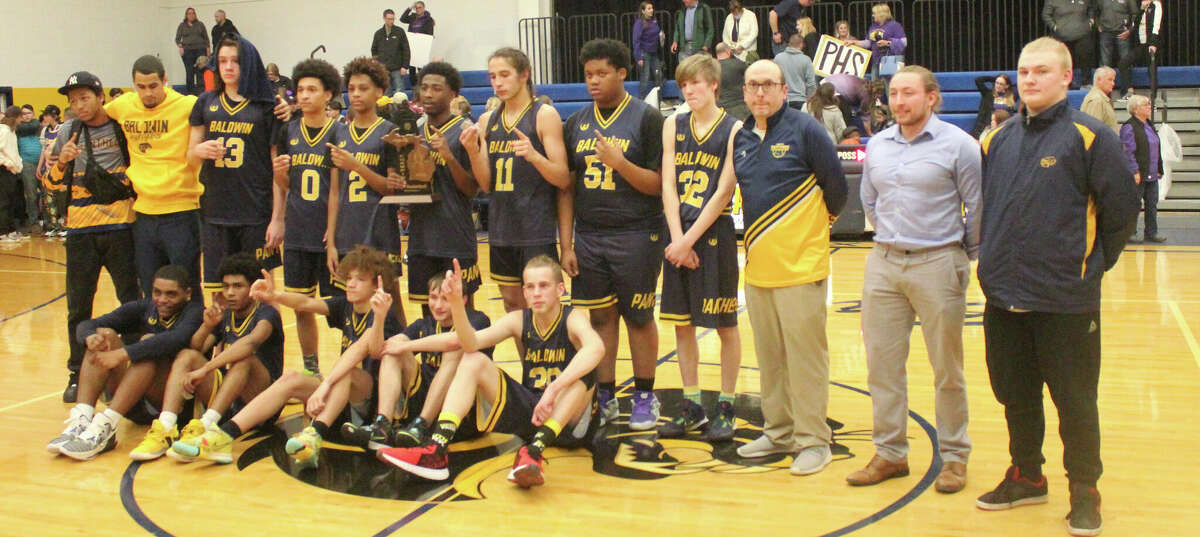 Baldwin's boys basketball team celebrated a district title on Friday.