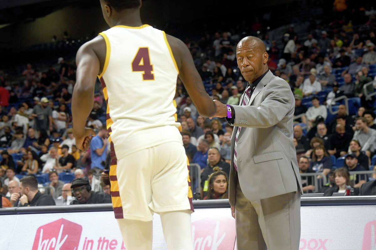 Coach David Green fist bumps Trealyn Porchia as Beaumont United takes the court to face Brennan in the 6A state semi final at the Alamodome Friday. Photo made Friday, March 10, 2023 Kim Brent/Beaumont Enterprise