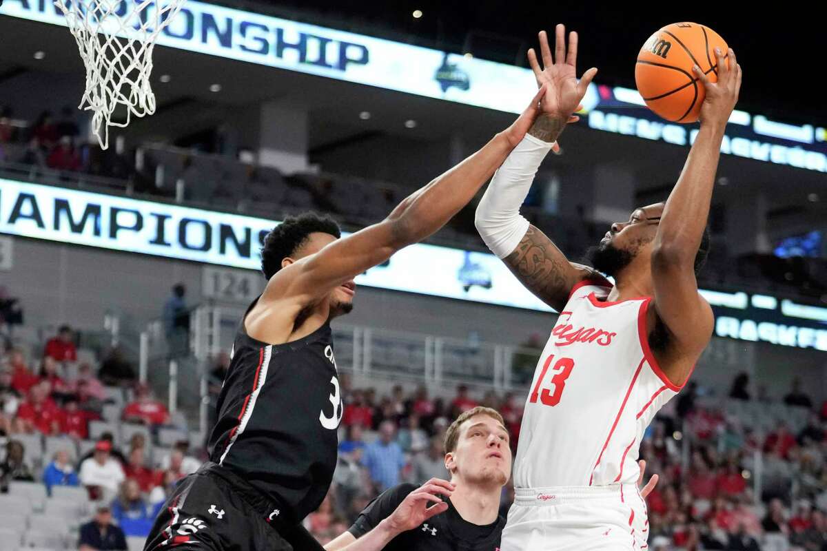 Houston forward J'Wan Roberts (13) takes a shot against Cincinnati during the first half of a semifinal basketball game in the American Athletic Conference men's basketball tournament on Saturday, March 11, 2023, in Fort Worth.