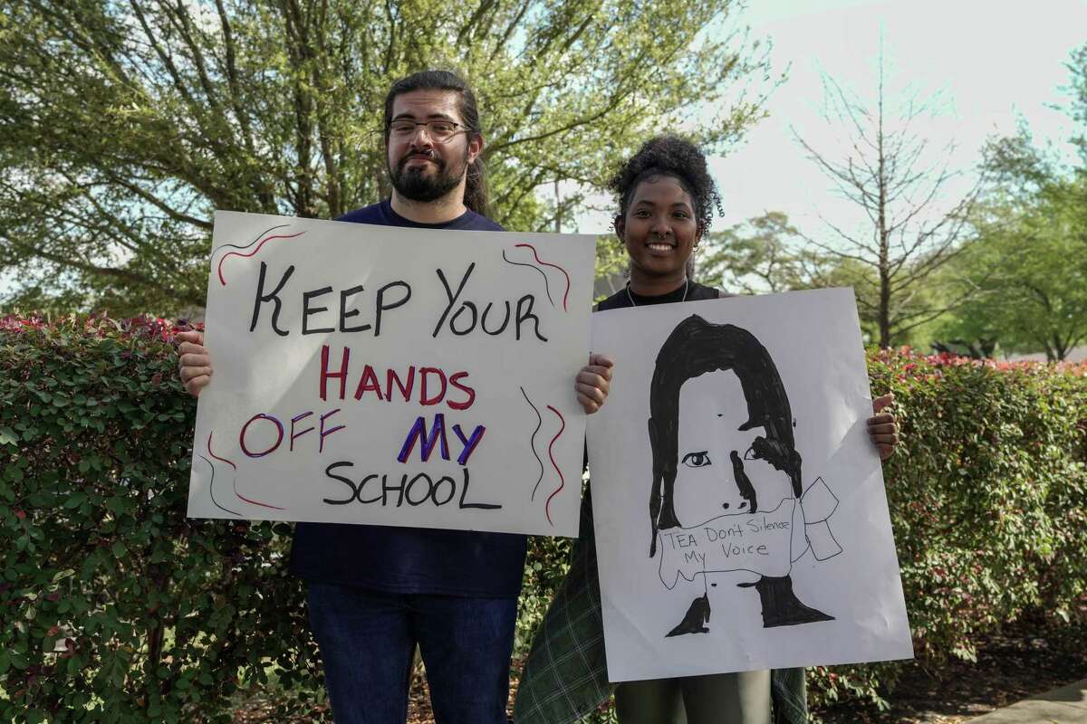 Teacher Nico Abazajin, 28, and Breland Paterson, 24, join parents, students, teachers and community members to protest the takeover of Houston ISD by the Texas Education Agency on Friday March 10, 2023 in Houston.