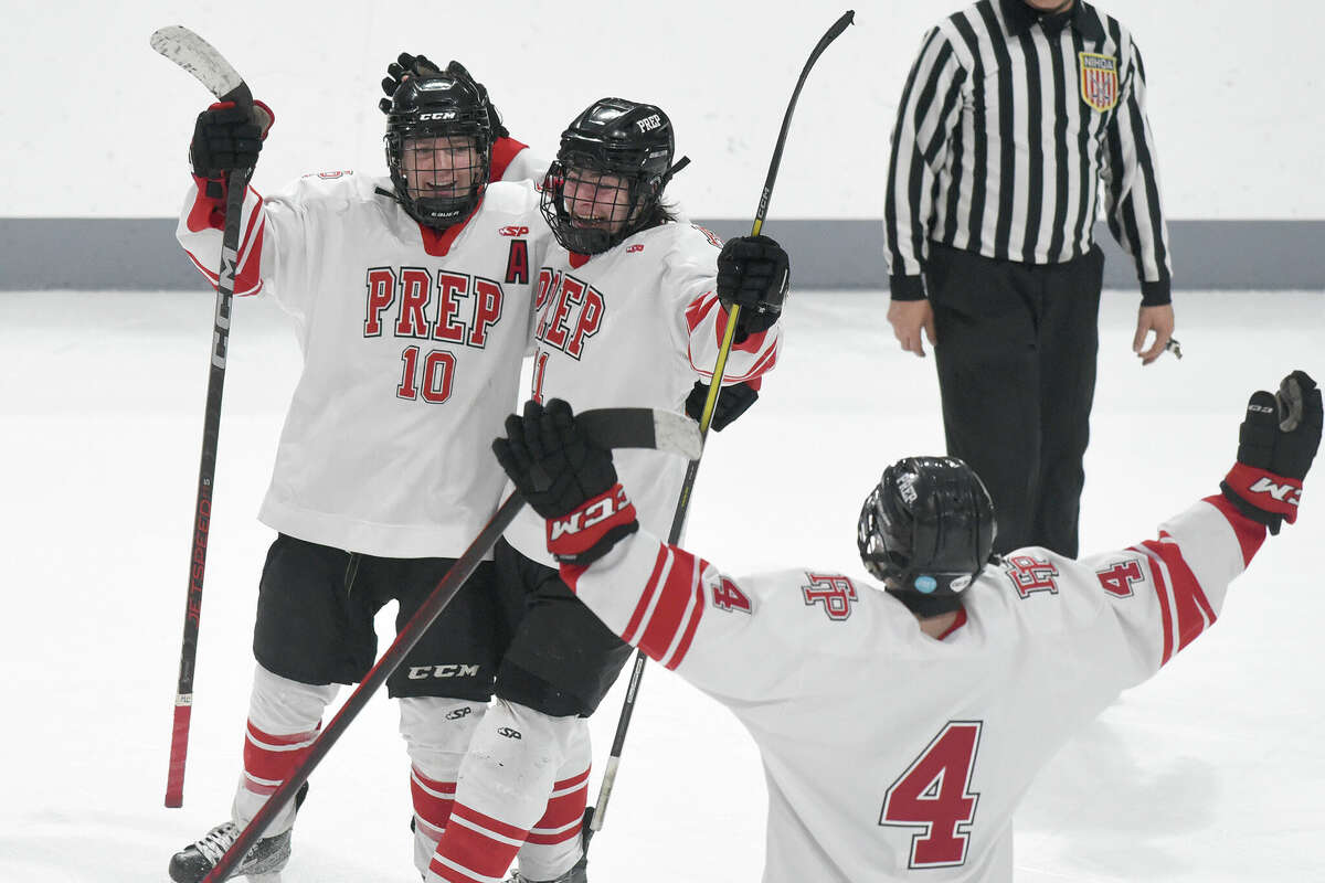Fairfied Prep's Zachary McCarthy (10), Owen McNicholas (11) and William Donnelly (4) celebrate after McNicholas scored the final goal in a 4-2 win over Notre Dame-Fairfield in the CIAC Div. I boys ice hockey quarterfinals at Sacred Heart University on Saturday, March 11, 2023.