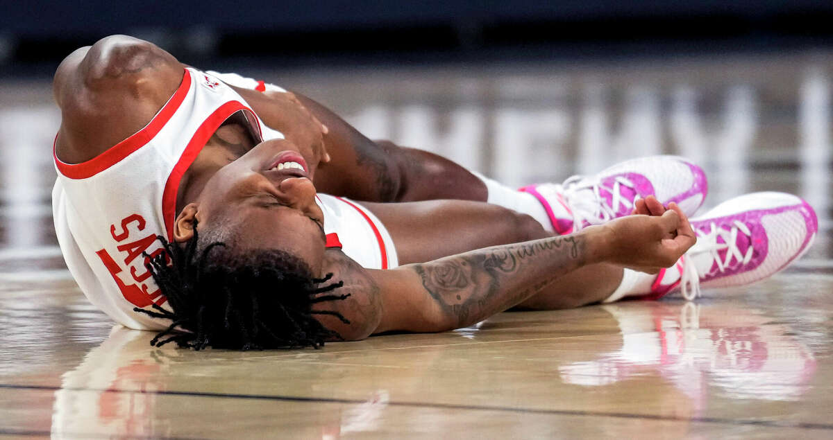 Houston guard Marcus Sasser (0) falls the court with an injury against Cincinnati during the first half of a semifinal basketball game in the American Athletic Conference men's basketball tournament on Saturday, March 11, 2023, in Fort Worth.