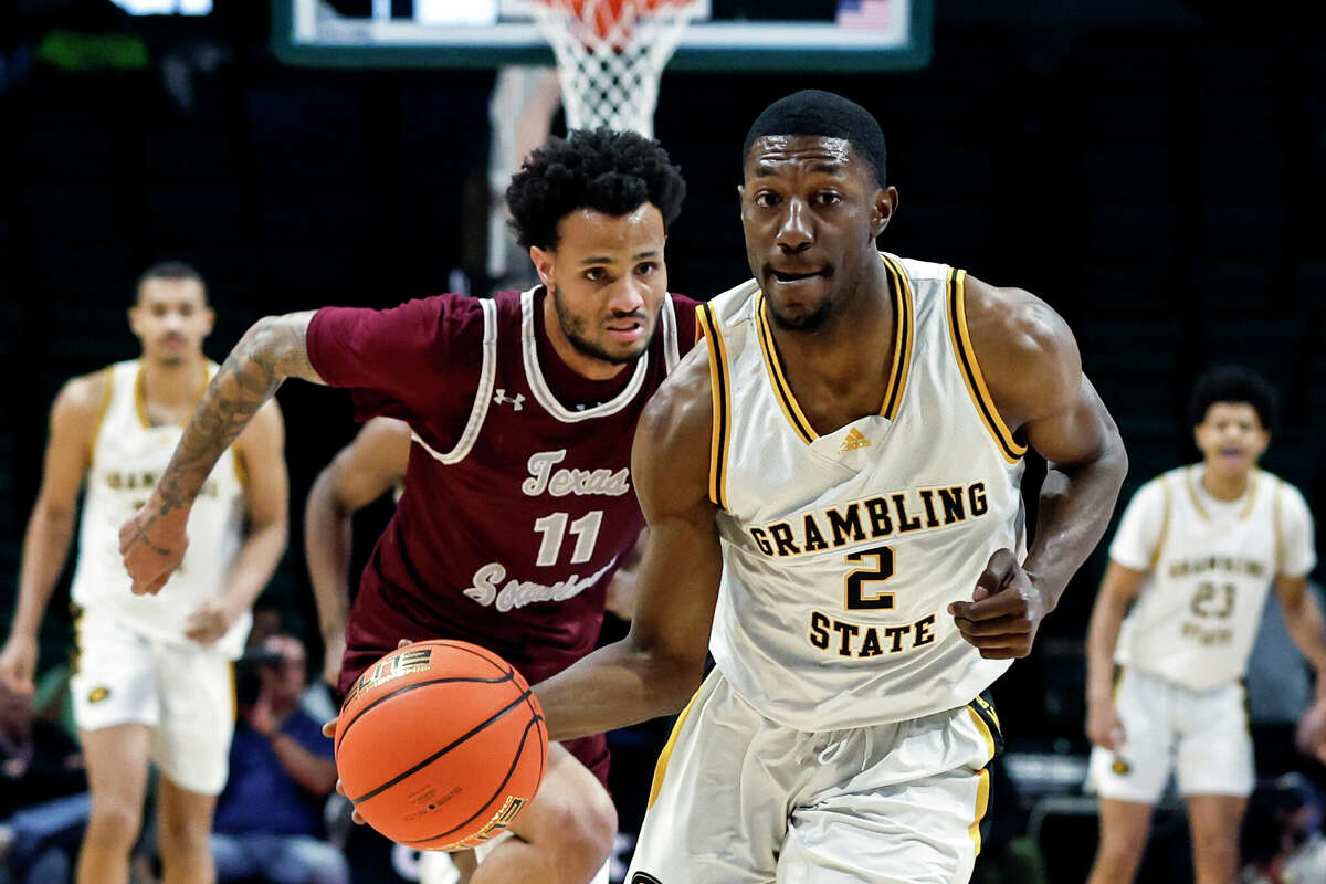 Grambling State guard Zahad Munford (2) dribbles the ball as Texas Southern guard Jordan Gilliam (11) pursues during the first half of an NCAA college basketball game in the championship of the Southwestern Athletic Conference Tournament, Saturday, March 11, 2023, in Birmingham, Ala. (AP Photo/Butch Dill)