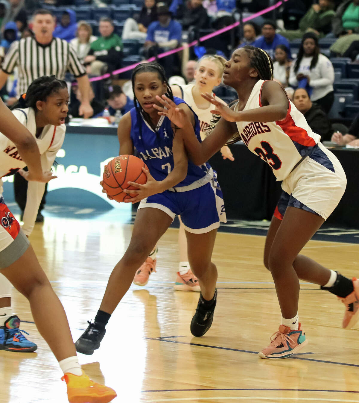Albany's Nevaeh House drives through three Liverpool defenders during the Class AA state quarterfinal game against Liverpool on Saturday at SRC Arena on March 11, 2023.