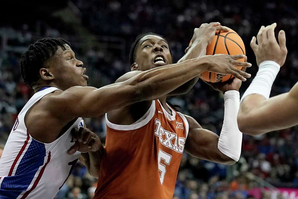 Texas guard Marcus Carr (5) shoots under pressure from Kansas guard Joseph Yesufu (1) during the first half of the NCAA college basketball championship game of the Big 12 Conference tournament Saturday, March 11, 2023, in Kansas City, Mo.