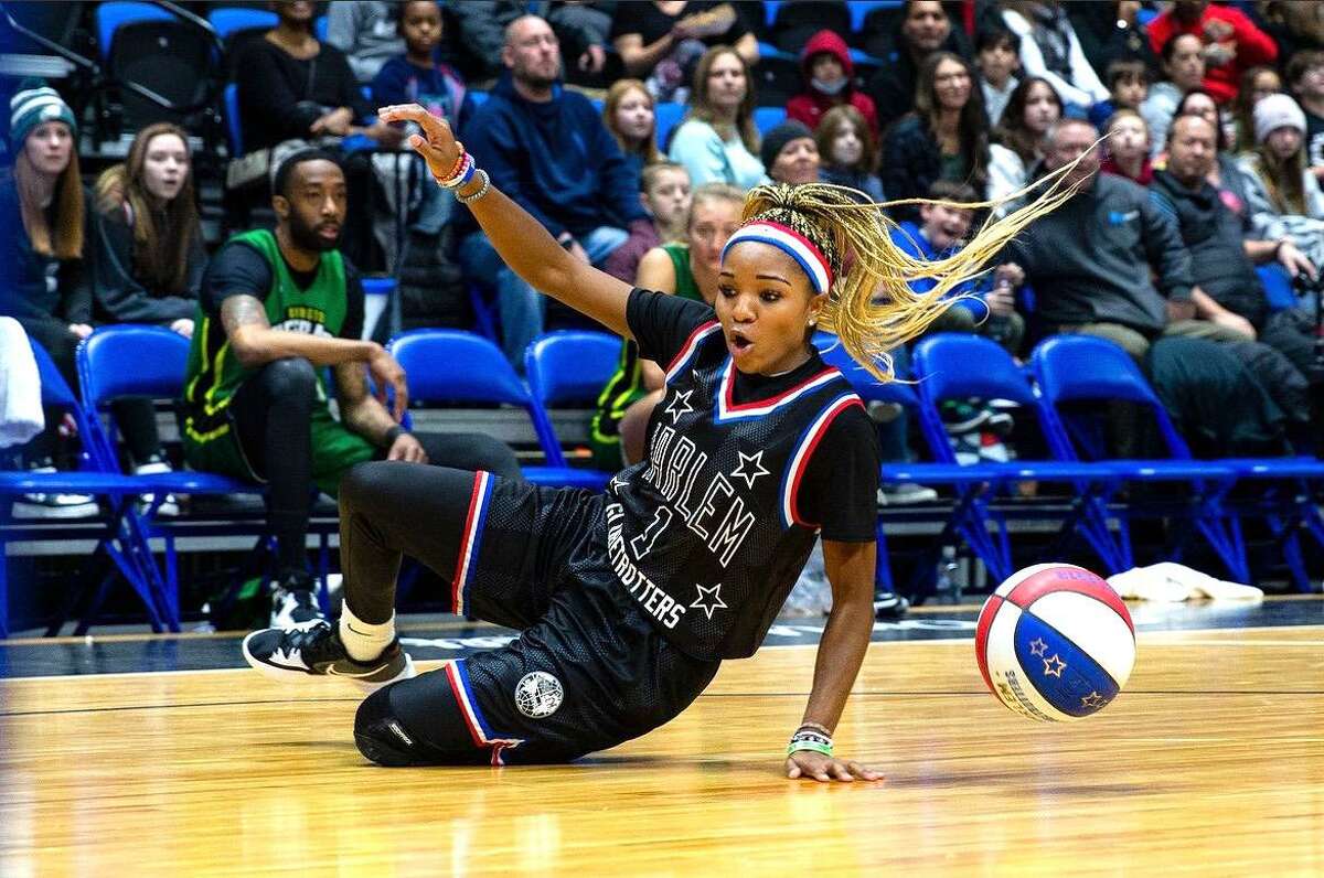 San Antonio native Arysia Porter displays one of her many moves before a crowd as one of six women who play for the world-famous Harlem Globetrotters.