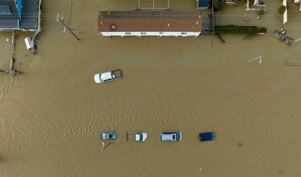 Cars and homes were engulfed by floodwaters in Pajaro, Calif., on Saturday.