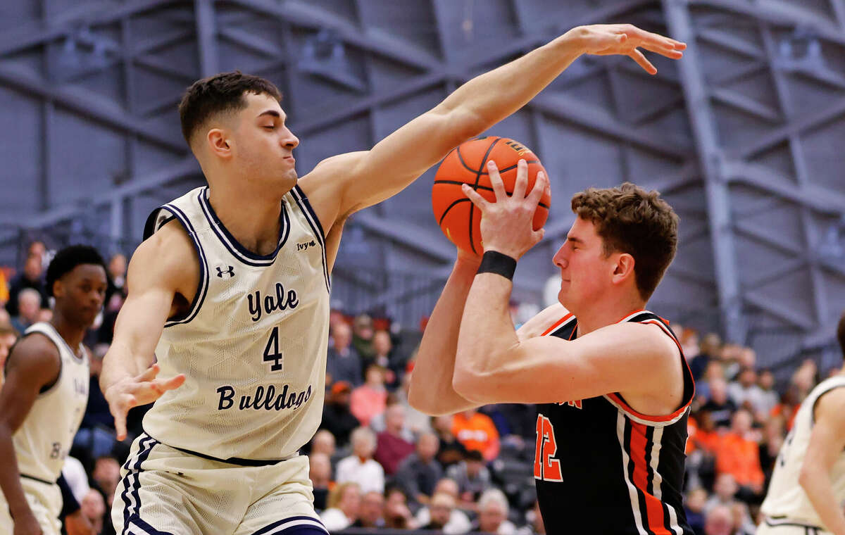 Yale John Poulakidas (4) defends against Princeton forward Caden Pierce (12) during the first half of the Ivy League championship NCAA college basketball game, Sunday, March 12, 2023, in Princeton, N.J. (AP Photo/Noah K. Murray)
