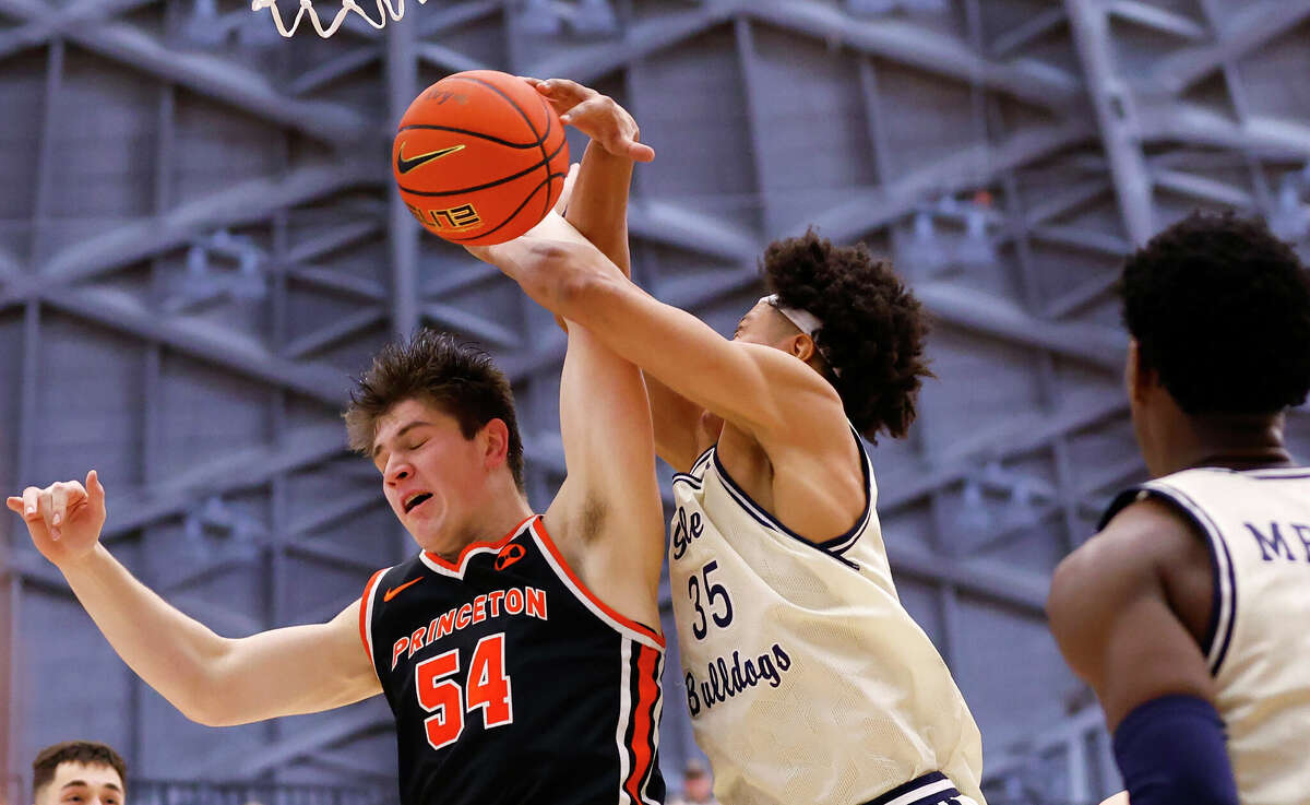 Princeton forward Zach Martini (54) battles Yale forward Isaiah Kelly (35) for a rebound during the first half of the Ivy League championship NCAA college basketball game, Sunday, March 12, 2023, in Princeton, N.J. (AP Photo/Noah K. Murray)