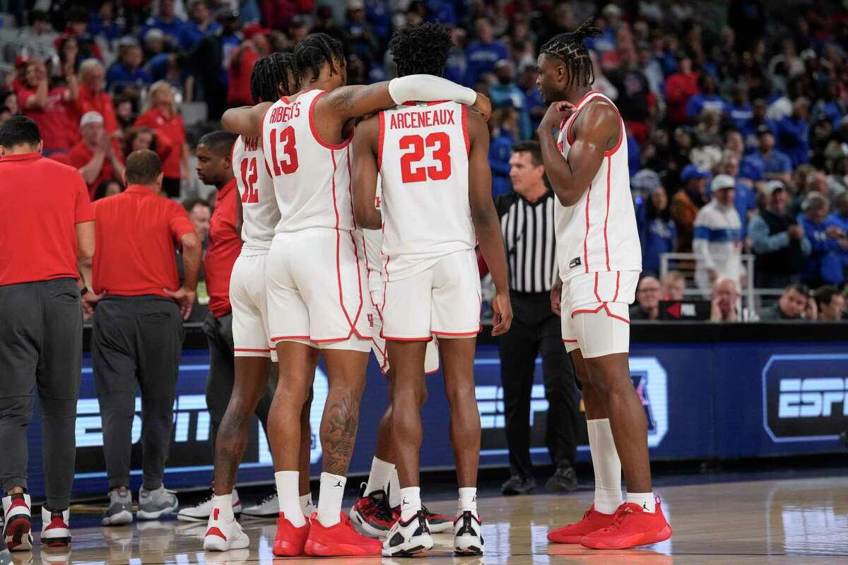 Houston players stand arm-in-arm during a time out late in the second half against Memphis in the American Athletic Conference men's basketball tournament championship game on Sunday, March 12, 2023, in Fort Worth.