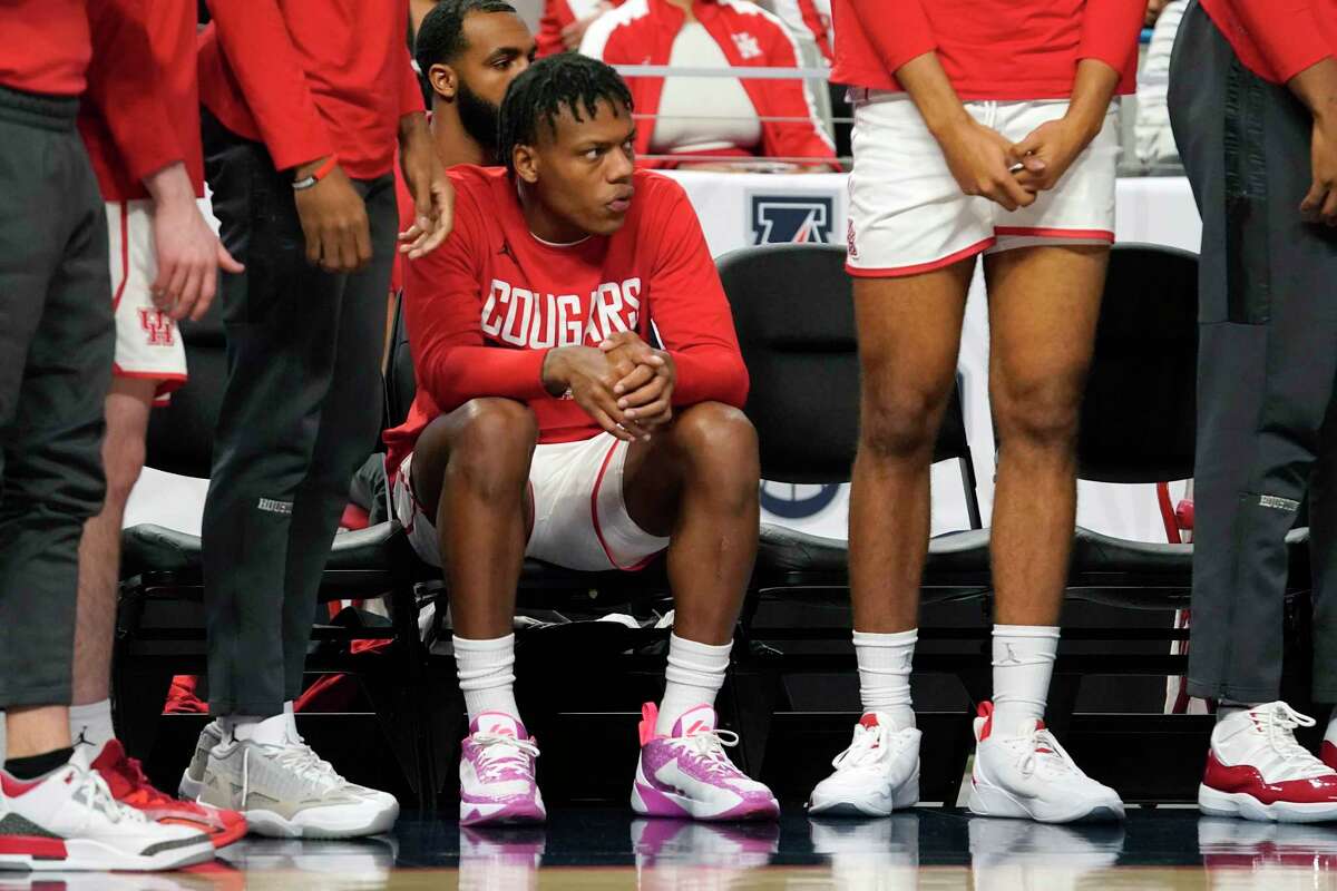 Houston's Marcus Sasser sits on the bench during the first half of an NCAA college basketball game against Memphis in the finals of the American Athletic Conference Tournament, Sunday, March 12, 2023, in Fort Worth, Texas.
