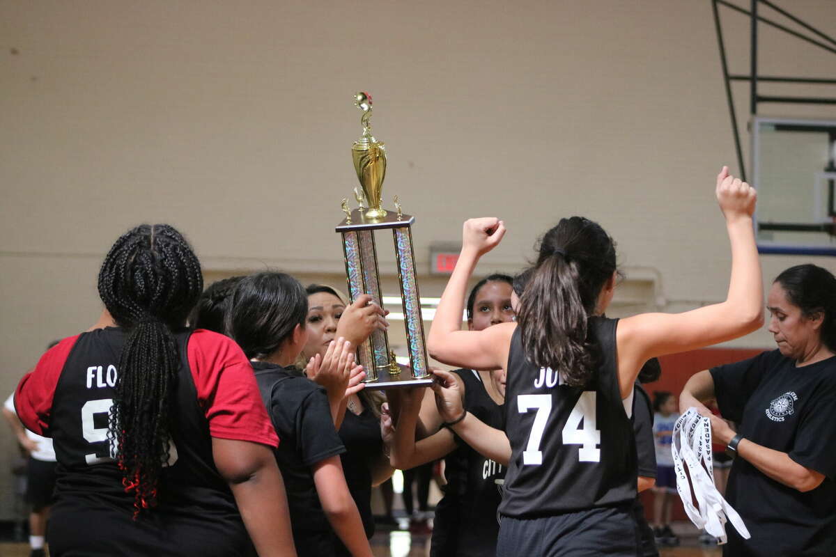 The Lady Rockets hoist the city championship trophy at PAL Gym Saturday, declaring them champs of the 9 and 10-year-old girls division.