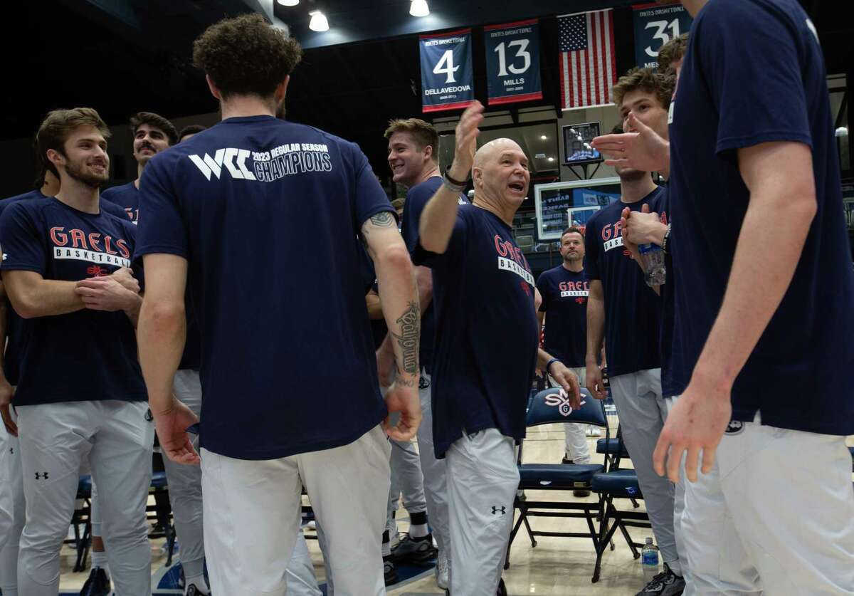 St. Mary's head coach Randy Bennett (center) celebrates with his players Sunday after they were revealed as the No. 5 seed in the West Region for the NCAA Tournament.