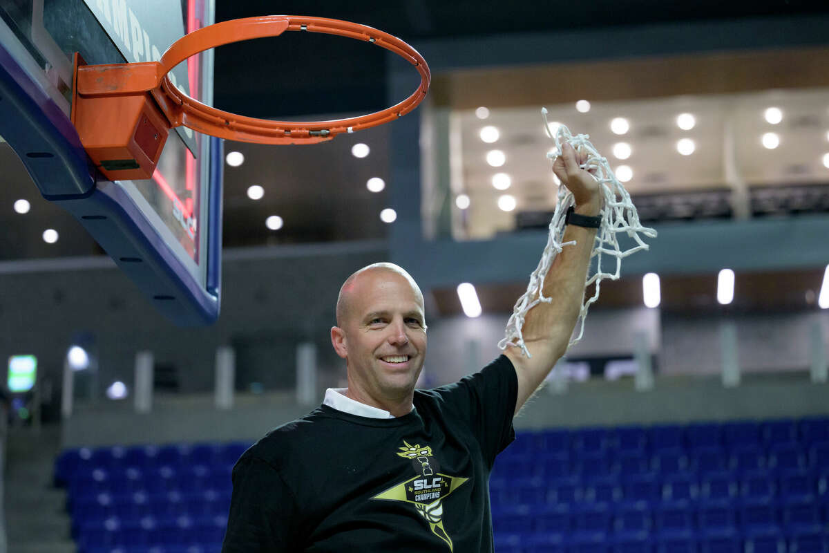 Texas A&M Corpus Christi head coach Steve Lutz cuts down the net after his team defeated Northwestern State during an NCAA college basketball game in the finals of the Southland Conference men's tournament in Lake Charles, La., Wednesday, March 8, 2023. (AP Photo/Matthew Hinton)