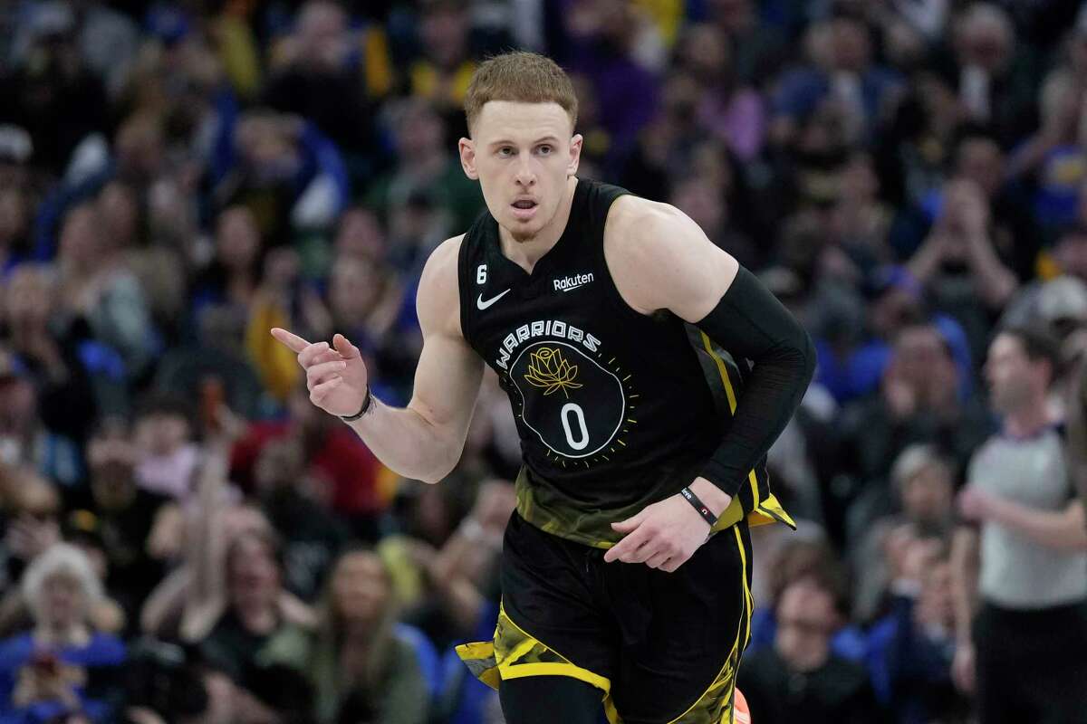 Warriors guard Donte DiVincenzo gestures after making a 3-pointer during Golden State's win over Milwaukee on Saturday. 
