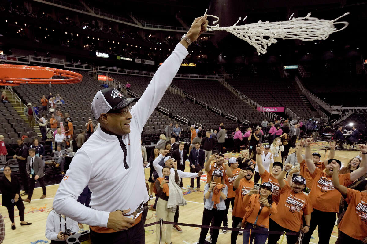 Interim Texas head coach Rodney Terry cuts the net after Texas won the Big 12 Conference tournament championship NCAA college basketball game Saturday, March 11, 2023, in Kansas City, Mo. Texas won 75-56. (AP Photo/Charlie Riedel)