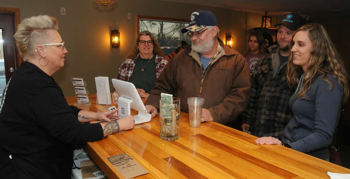 Steve's Old Cabin BBQ co-owner Laurie Helfer takes customer orders at the restaurant.